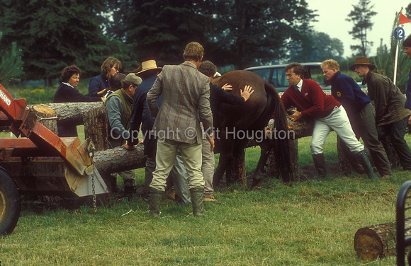 Horse being extracted from fixed cross country fence. Mike Etherington -Smith in red jersey. Top rail is lowered to allow horse to be released from fence. Prior to Frangible pins EV282-05-15