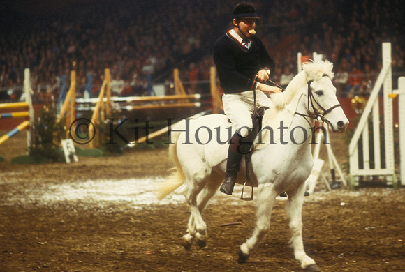 Harvey Smith takes part in a fancy dress competition, pretending to be a Pony Club rider, Olympia, 1978 SJ01-04-02