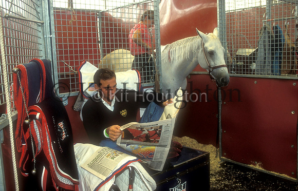 Greg Best reads the European newspaper in the stables Grand Prix de Paris SJ124-03-19.JPG