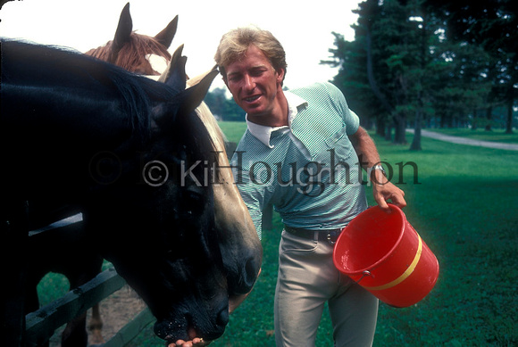 Bruce Davidson's Yard, Pennsylvania, USA,1981;;Bruce Davidson feeds young horses from bucketEV24-02