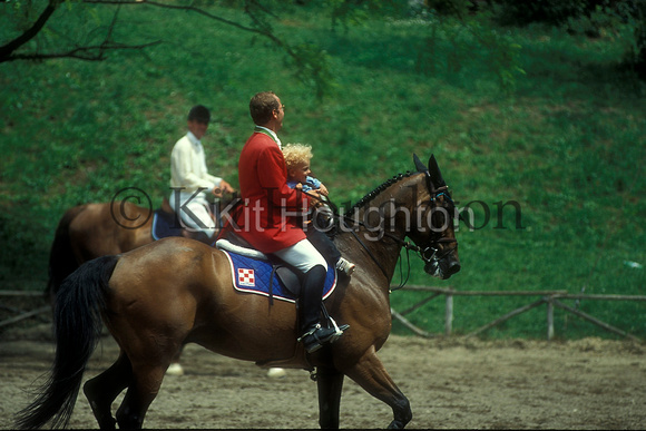 Showjumping rider with small child riding at Rome Show with riding hat SJ155-05-16