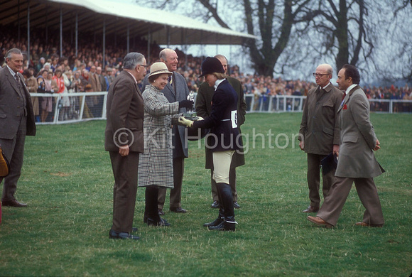 Lucinda Prior-Palmer receives  the Whitbread Trophy fromn H M The Queen watched by Col Whitbread and Col Frank Weldon with horse's Owner Charles CyzerEV01-13-11