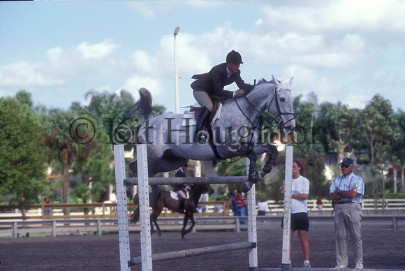 Jumping a practise fence in the warm up area SJ154-06-01