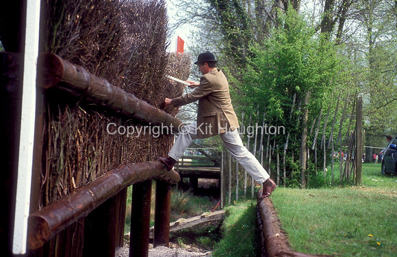 Fence judge examining the Brush Fence and patting down the birch EV424-05-02