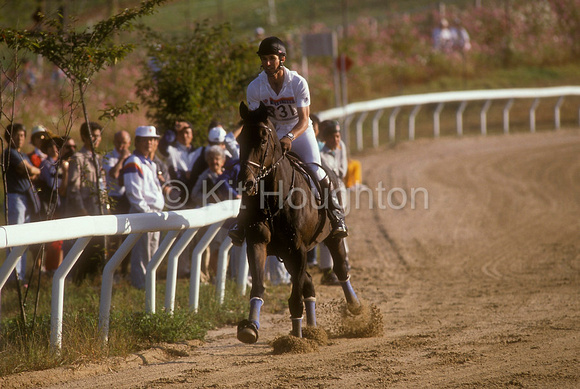 Captain Mark Phillips and Cartier gallop on the steeplechase course. He pulled out after cartier pulled up lame. EV204-19-03